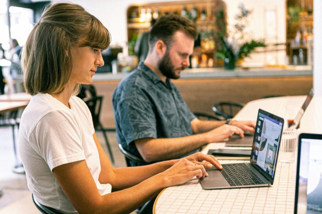 2 people working on their laptops